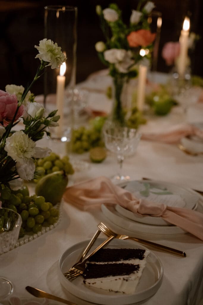 Candlelit wedding table setting with plate and decor at Rivers Edge Resort's cottage core wedding reception in Manitoba