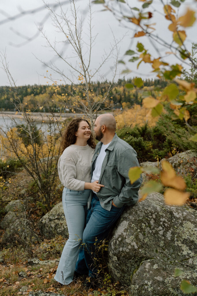 A couple taking engagement photos at west hawk lake