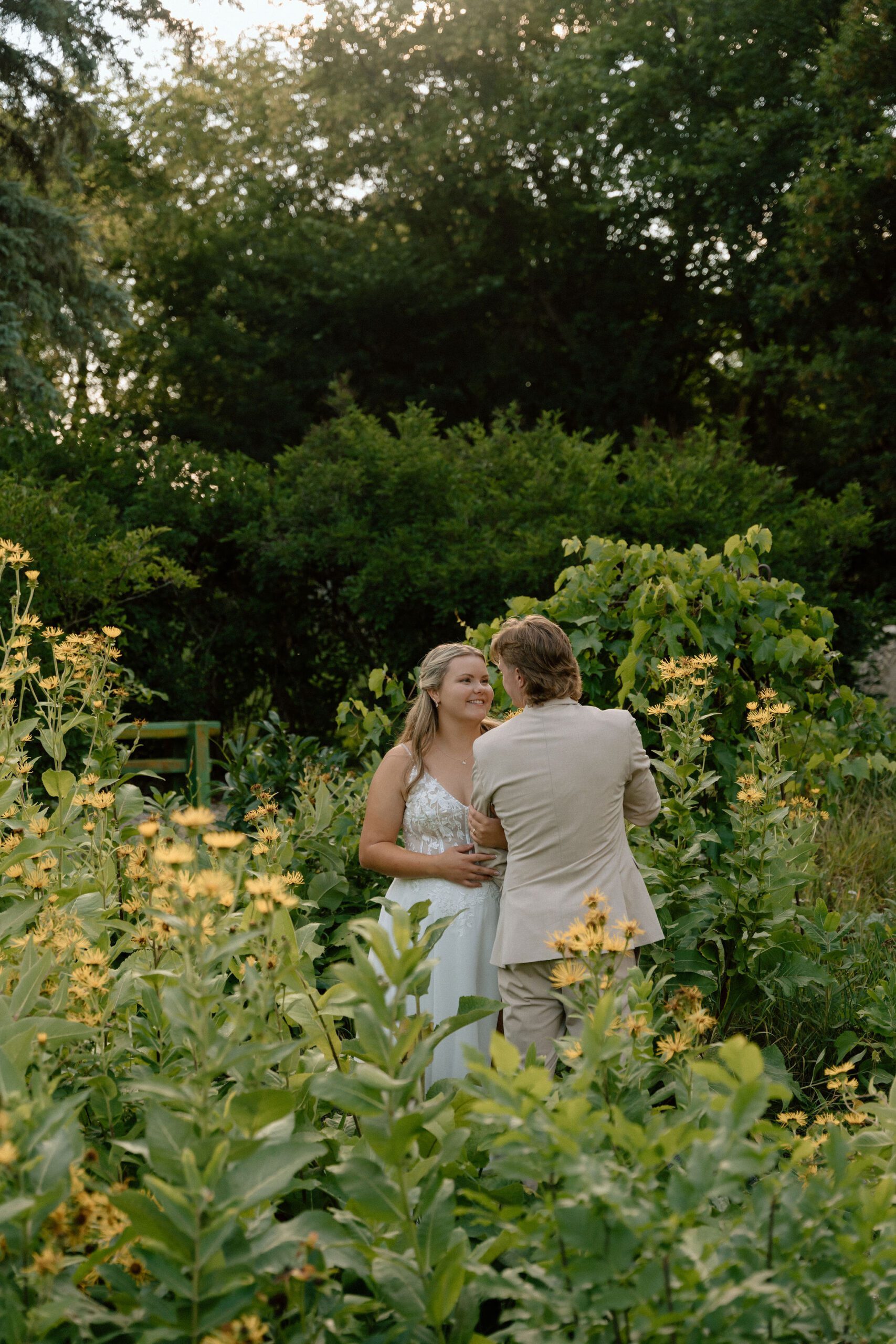 bride and groom in the garden at the St. Norbert Arts Center