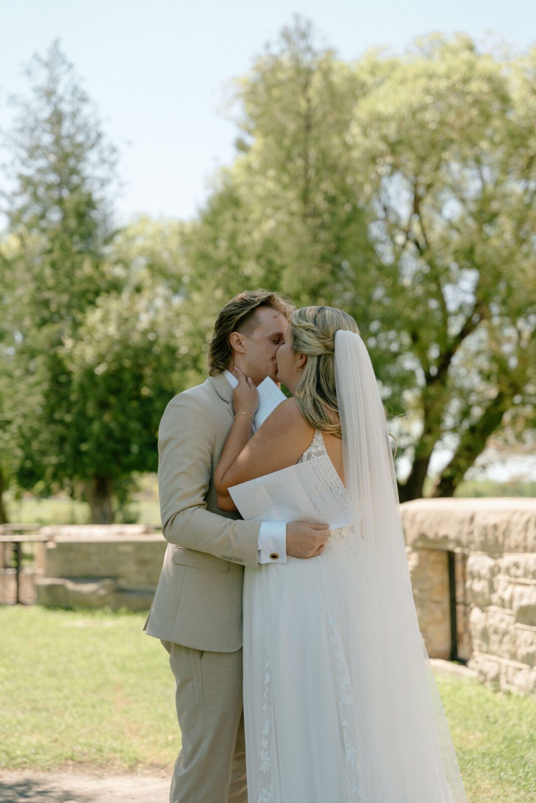 bride and groom kissing in front of the trappist monestary in winnipeg