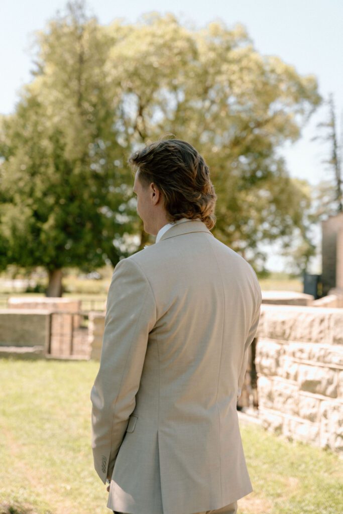 groom waiting for his first look on his wedding day in winnipeg