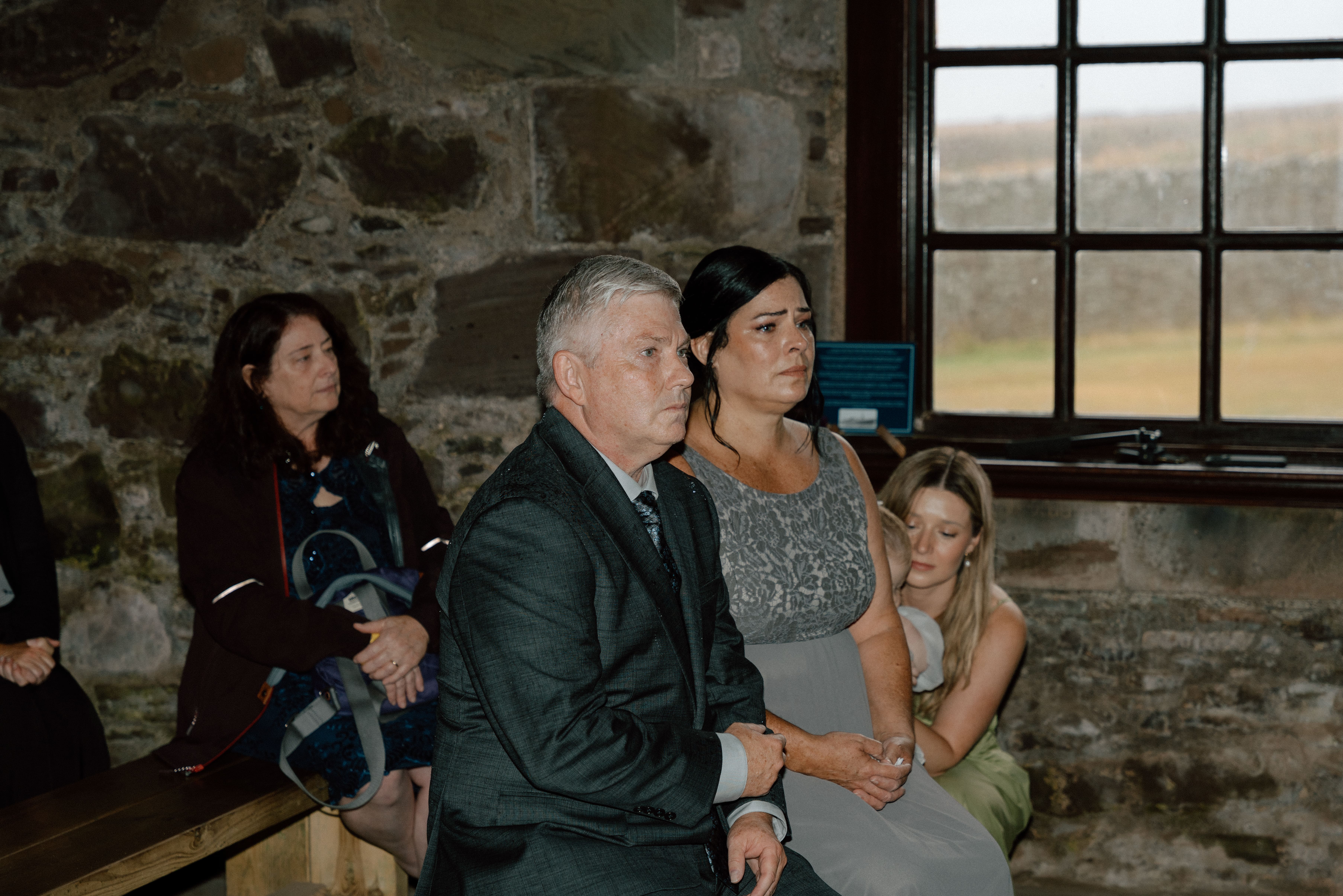 bride's parents emotional during wedding ceremony at Dunnottar Castle Scotland