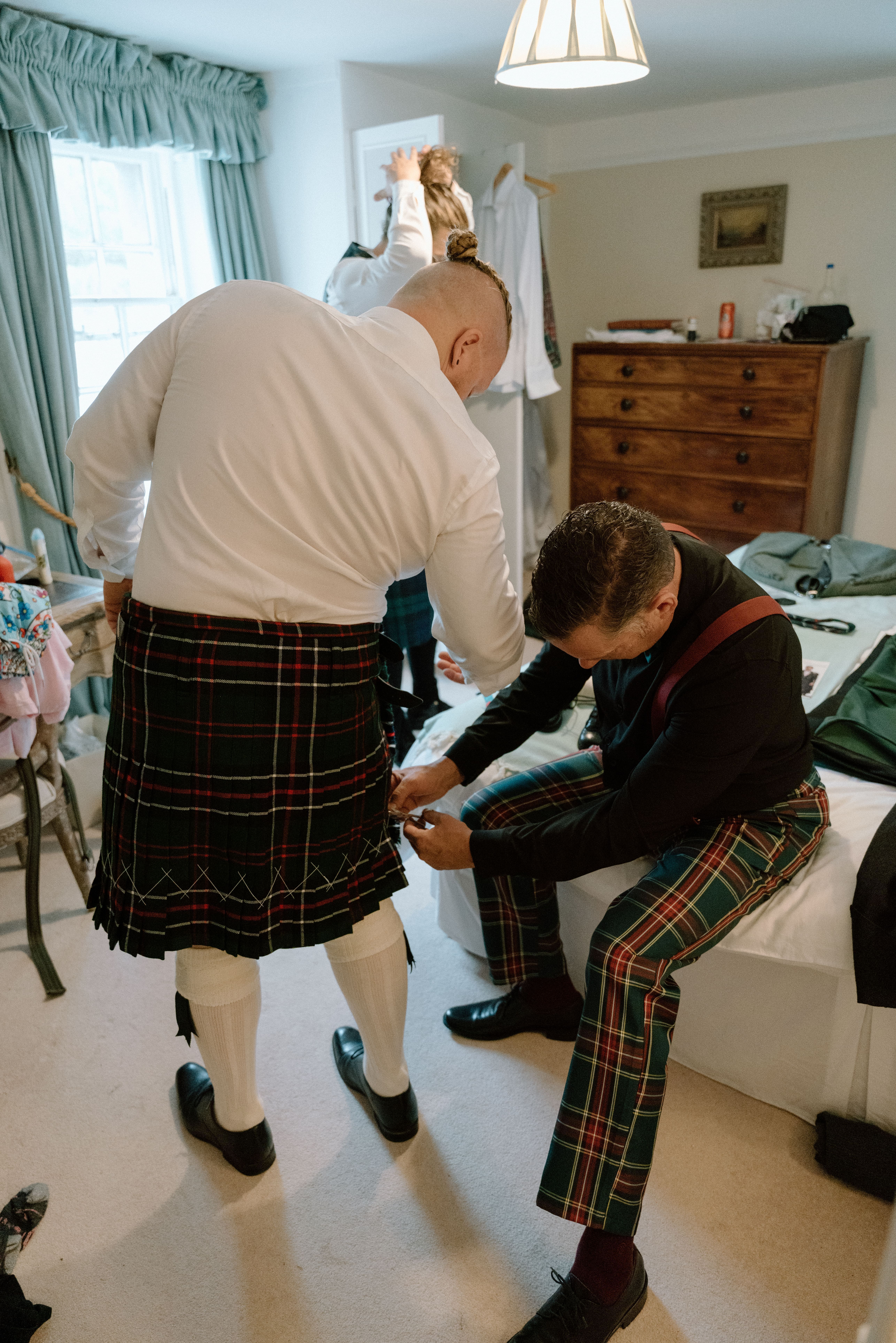 Relaxed wedding morning photography of the groom and groomsmen getting ready with his groomsmen at Elsick House in Scotland.
