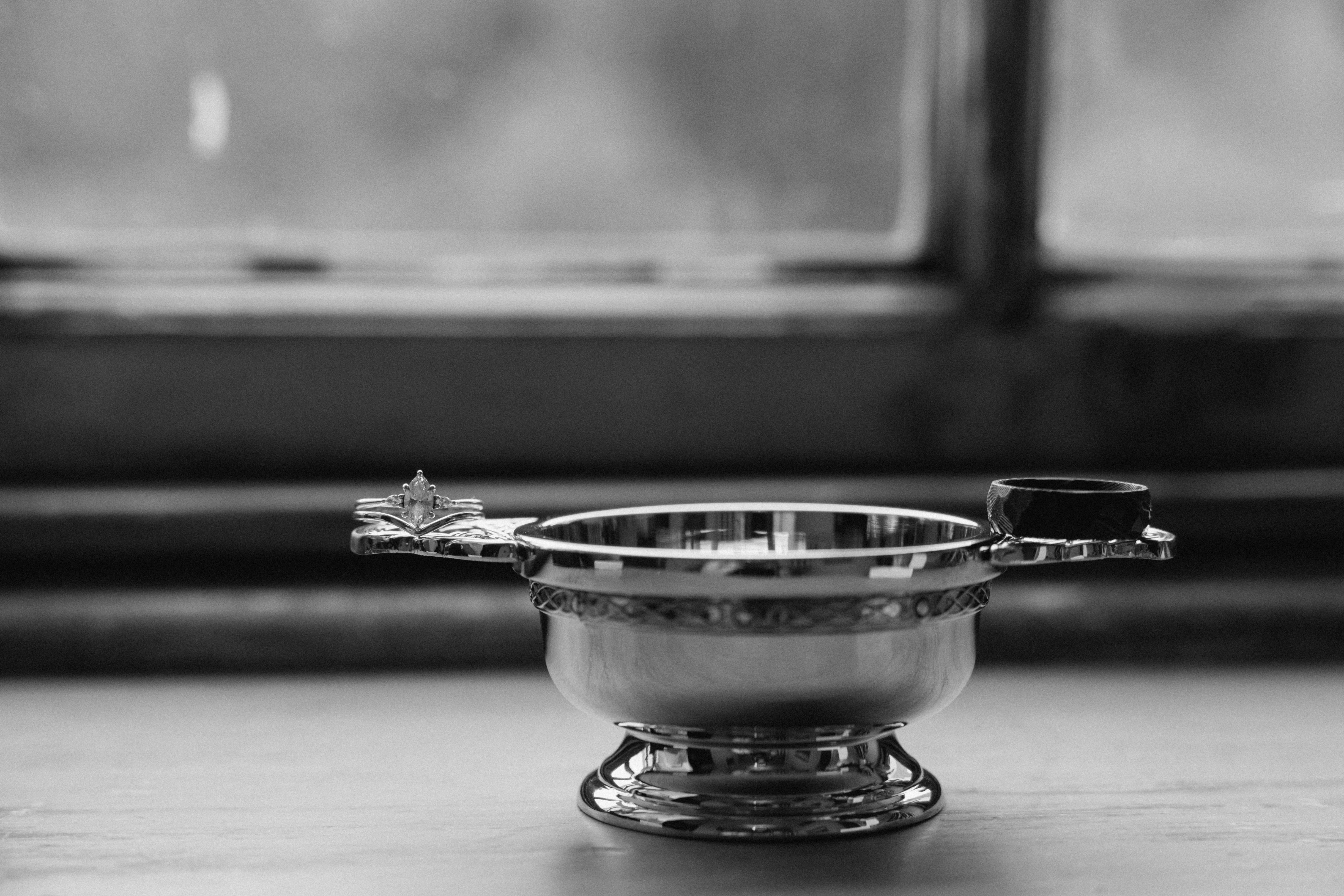 Monochrome close-up wedding detail of a traditional Scottish Quaich cup, highlighting cultural heritage and symbolism during a wedding celebration in Scotland.
