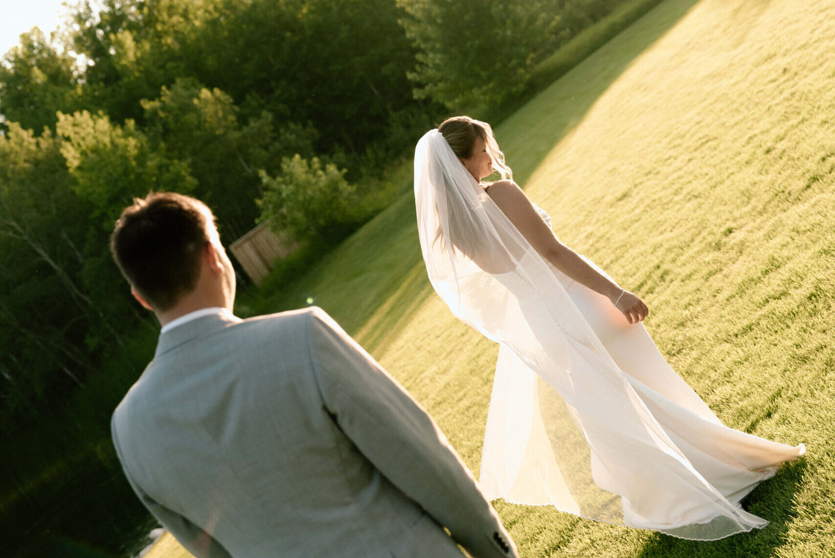 Julianna and Cole photographed at golden hour during their timeless wedding at The White Poplar in Manitoba