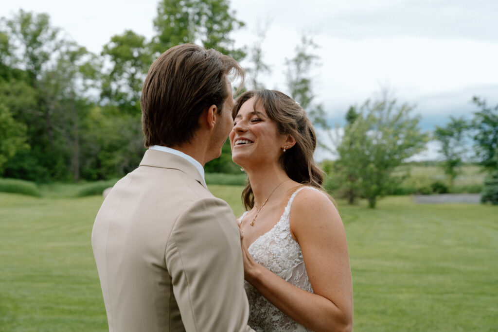 Kayla and Myles smiling together during their wedding portraits at Hawthorne Estates in Manitoba