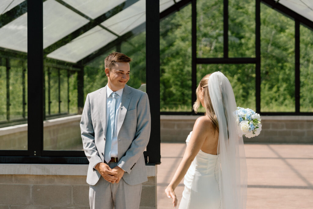 Julianna showing off her wedding dress to Cole for their first look at The White Poplar in Manitoba