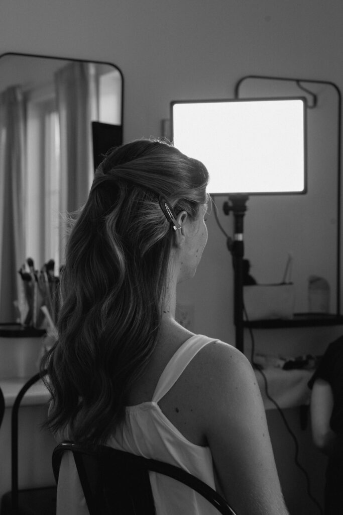 Julianna getting ready for her wedding at The White Poplar in Manitoba, captured in a timeless black and white wedding photograph