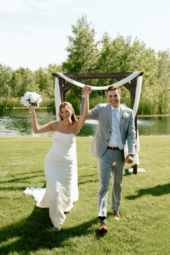 Julianna and Cole walking together after their wedding ceremony during their White Poplar wedding recessional