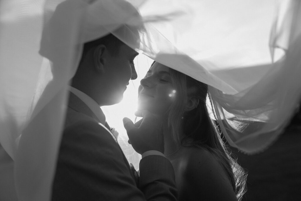 Julianna and Cole beneath the veil in a classic black and white wedding portrait at The White Poplar