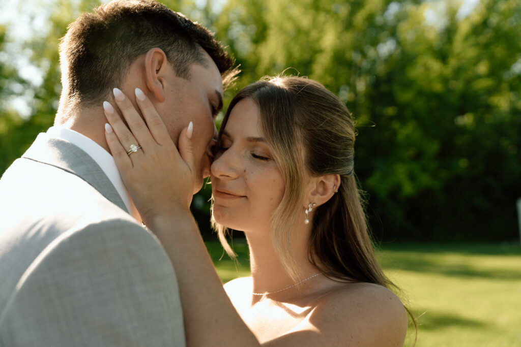 Julianna and Cole sharing a romantic, classic wedding portrait as they kiss at The White Poplar
