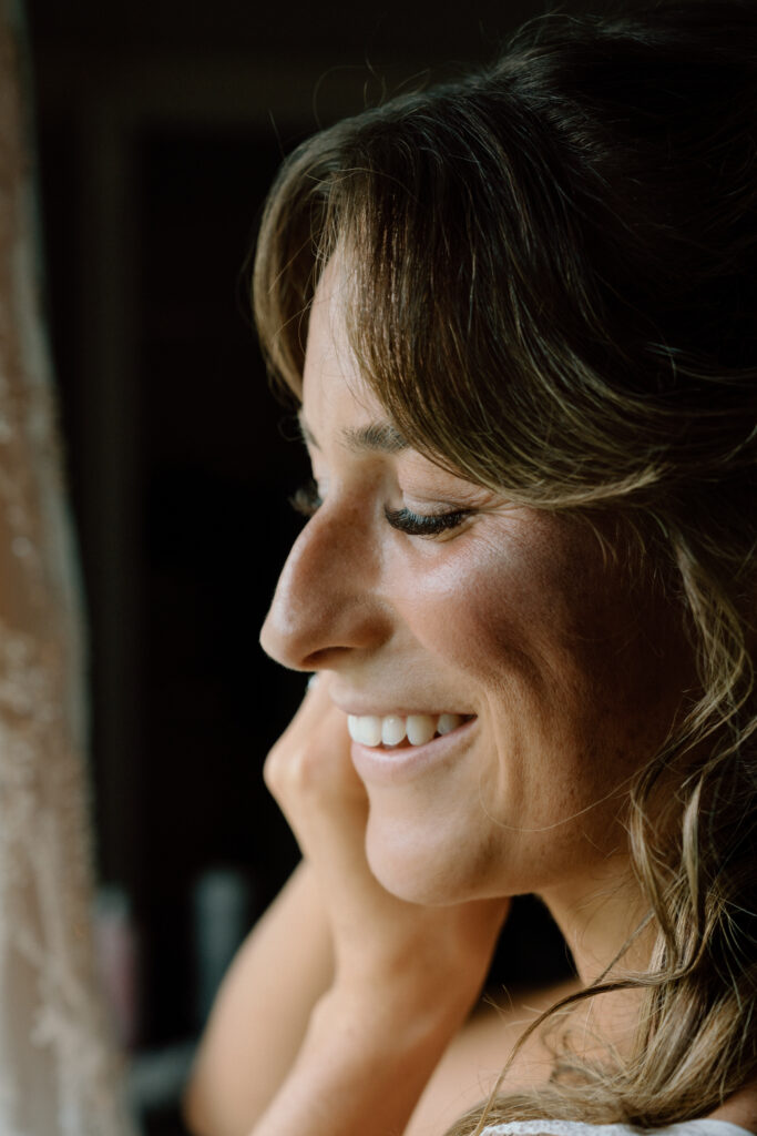 Close-up of Kayla wearing her wedding earrings while getting ready at Hawthorne Estates