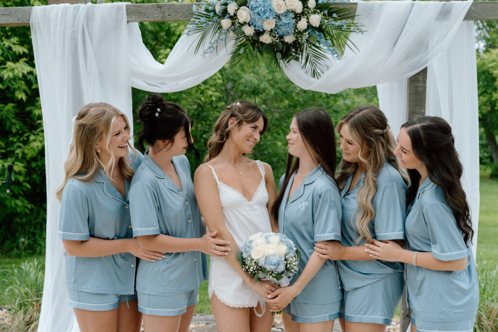 Kayla sharing a candid moment with her bridesmaid while getting ready for her wedding at Hawthorne Estates
