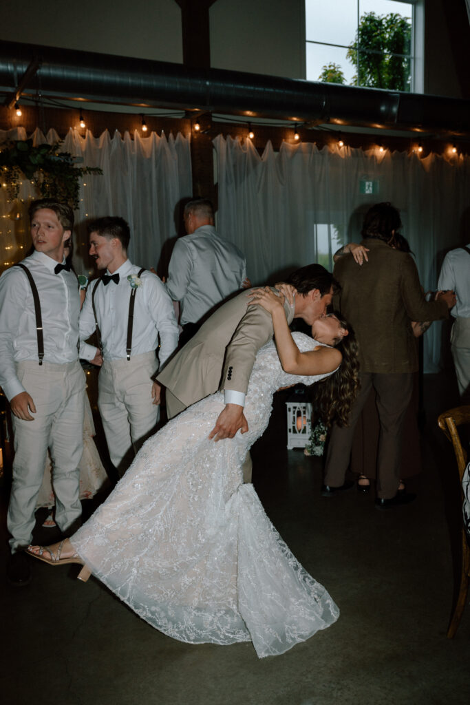 Myles dipping Kayla and kissing her during their wedding reception at Hawthorne Estates in Manitoba