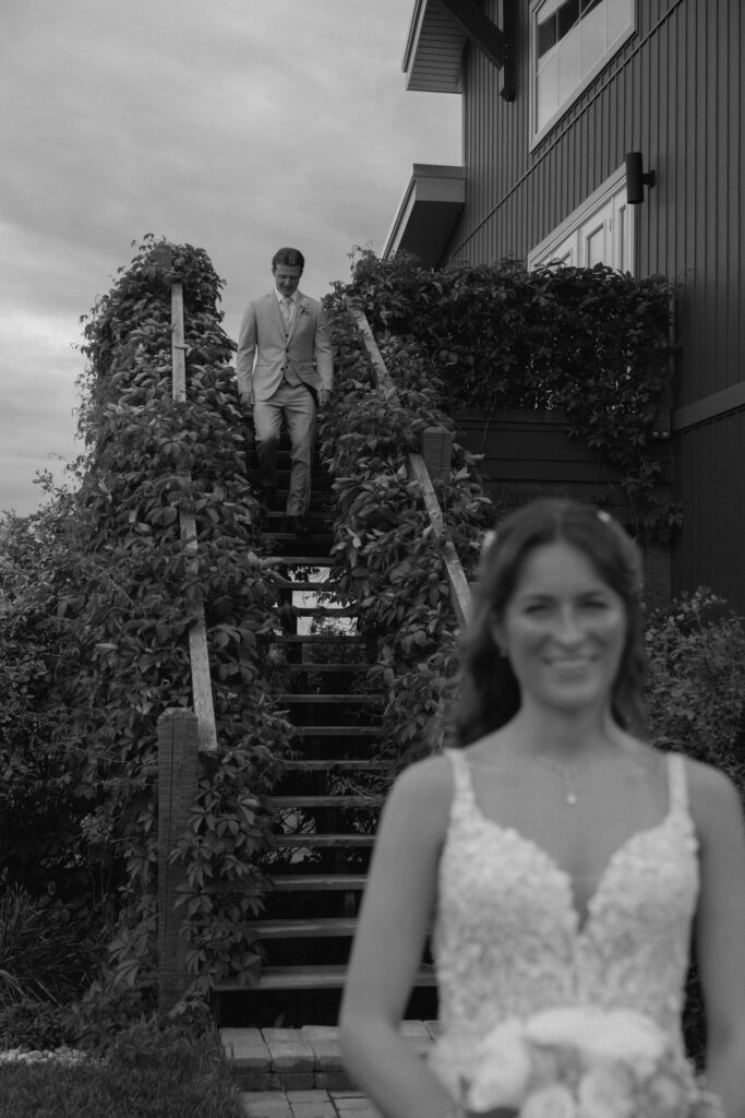Myles walking toward Kayla during their wedding day first look at Hawthorne Estates