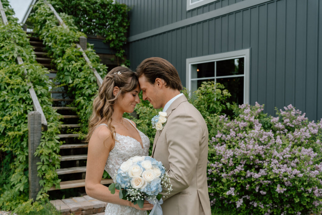 Kayla and Myles touching foreheads during an intimate wedding portrait at Hawthorne Estates in Manitoba