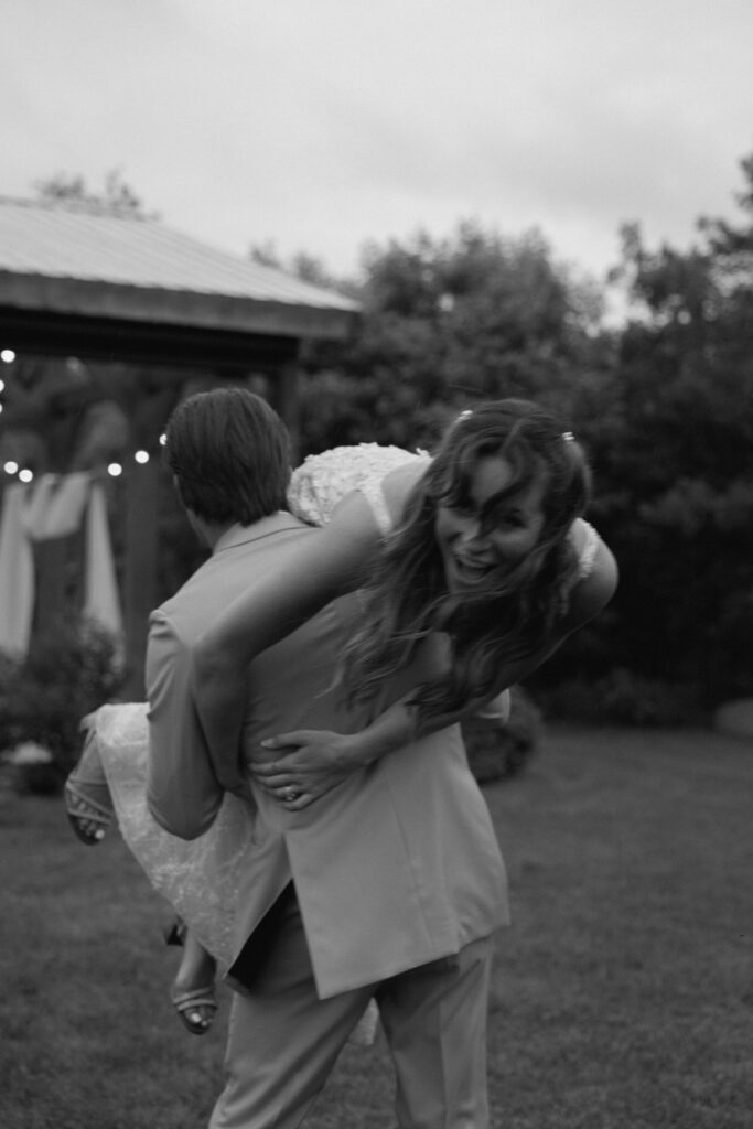 Kayla smiling over Myles’ shoulder during their classic wedding portraits at Hawthorne Estates in Manitoba